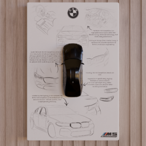 Top-view 3D-printed BMW M5 CS miniature in gloss-black finish mounted on a white panel with sketch background